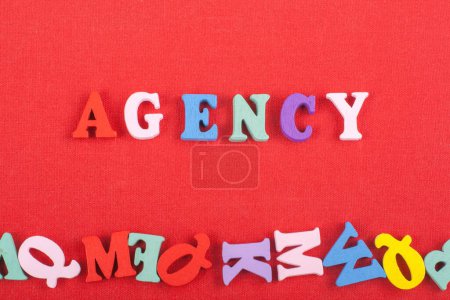 Photo for AGENCY word on red background composed from colorful abc alphabet block wooden letters, copy space for ad text. Learning english concept - Royalty Free Image