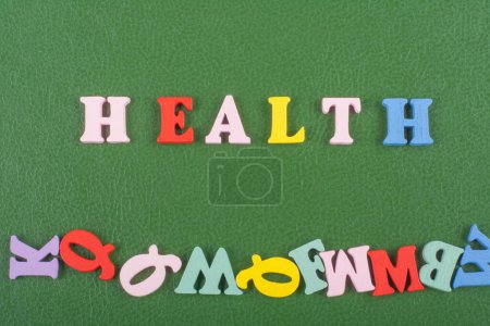 Photo for HEALTH word on green background composed from colorful abc alphabet block wooden letters, copy space for ad text. Learning english concept - Royalty Free Image