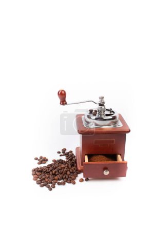 Pile of coffee beans, coffee grinder, ground coffee on a white background. Top view. Banner
