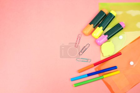 Photo for Back to school. Stationery on a salmon color table. Office desk with copy space. Flat lay - Royalty Free Image