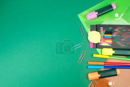 Photo for Back to school. Stationery on a green table. Office desk with copy space. Flat lay - Royalty Free Image