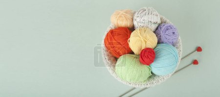 Photo for Color yarn. Cells of woolen yarn for knitting. A ball of wool with knitting needles of different colors for handmade knitting. The upper view with a copy space. Banner - Royalty Free Image