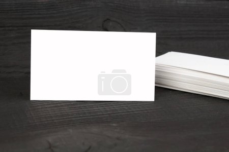 Photo for Blank business cards on the Black wooden table. Template for ID. Top view - Royalty Free Image