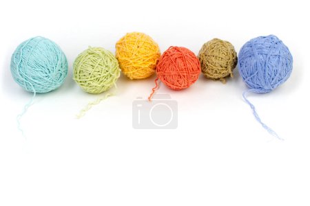 Photo for Colored yarn on a white background. Skeins of wool yarn for knitting. Balls of wool of different colours for handmade knitting on a wooden background with copy space for ad - Royalty Free Image