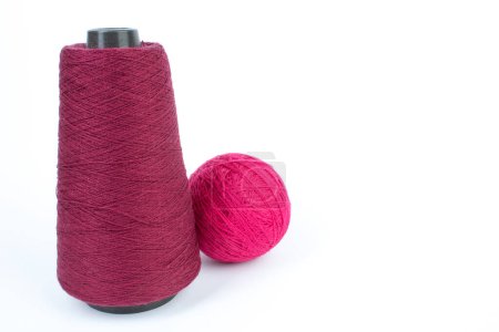 Knitting yarn for knitting on white background. red