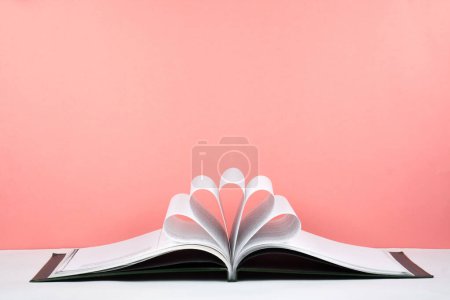 Photo for Old open hardback book, page decorate into a flower shape for love in Valentine's. love with open book heart - Royalty Free Image