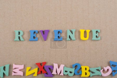 Photo for REVENUE word on paper background composed from colorful abc alphabet block wooden letters, copy space for ad text. Learning english concept - Royalty Free Image