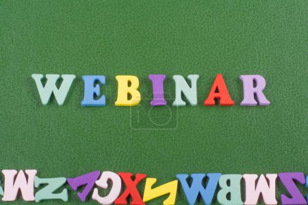 Photo for WEBINAR word on green background composed from colorful abc alphabet block wooden letters, copy space for ad text. Learning english concept - Royalty Free Image