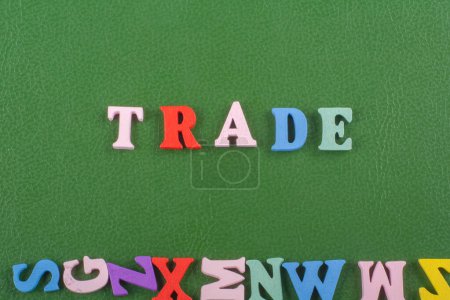 TRADE word on green background composed from colorful abc alphabet block wooden letters, copy space for ad text. Learning english concept