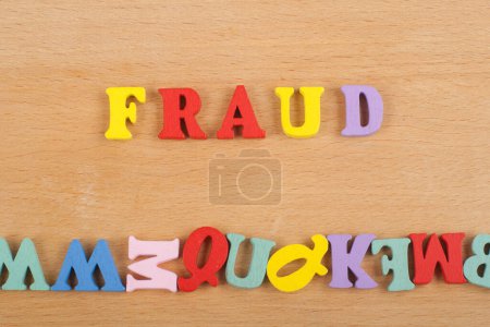 Photo for FRAUD word on wooden background composed from colorful abc alphabet block wooden letters, copy space for ad text. Learning english concept - Royalty Free Image