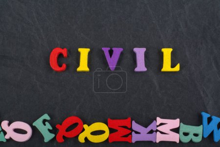 CIVIL word on black board background composed from colorful abc alphabet block wooden letters, copy space for ad text. Learning english concept