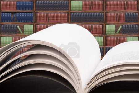 Photo for Books on the table in the library, against the background of wooden cabinets with books. Back to school. Education background. Copy Space - Royalty Free Image