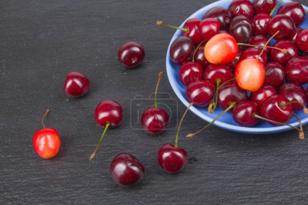 Photo for Various summer Fresh Cherry in a bowl on rustic wooden table. Antioxidants, detox diet, organic fruits - Royalty Free Image