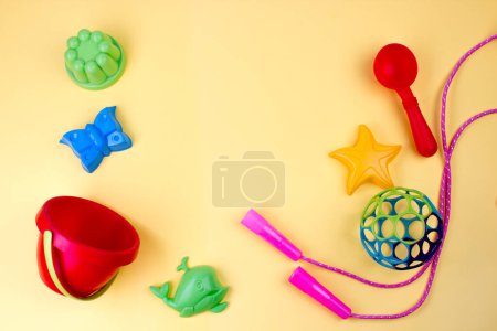 Multi-colored children's toys. On a yellow background.
