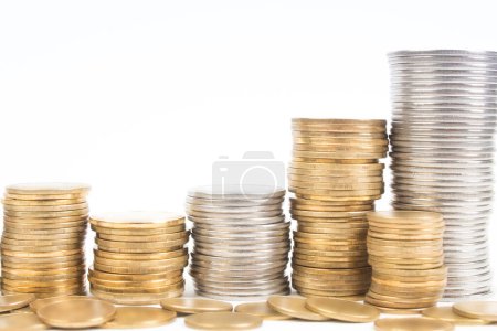 Gold towers made out of gold and silvery coins, stack isolated on white