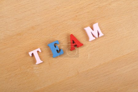 Photo for TEAM word on wooden background composed from colorful abc alphabet block wooden letters, copy space for ad text. Learning english concept - Royalty Free Image