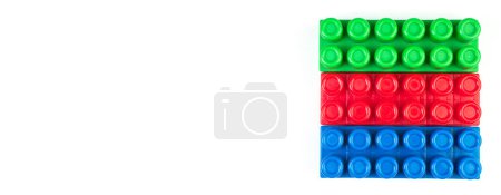 Lot of colorful rainbow toy bricks background. Educational toy, constructor for children Isolated on white background. 3D Rendering. Top view with copy space. Banner