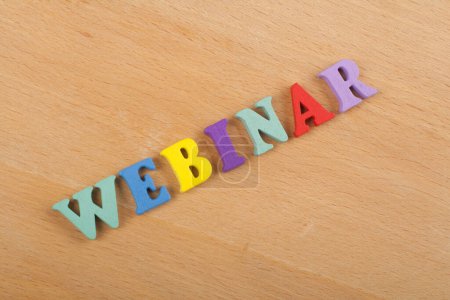 WEBINAR word on wooden background composed from colorful abc alphabet block wooden letters, copy space for ad text. Learning english concept