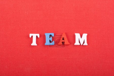 Photo for TEAM word on red background composed from colorful abc alphabet block wooden letters, copy space for ad text. Learning english concept - Royalty Free Image