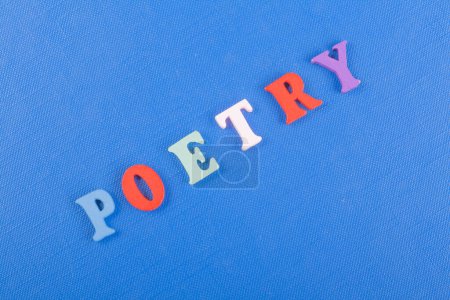 POETRY word on blue background composed from colorful abc alphabet block wooden letters, copy space for ad text. Learning english concept