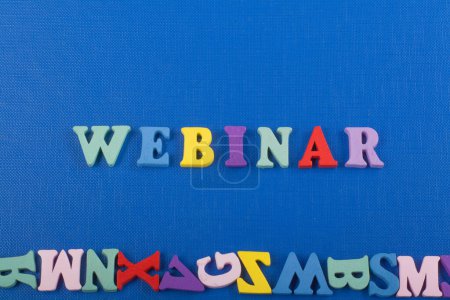 Photo for WEBINAR word on blue background composed from colorful abc alphabet block wooden letters, copy space for ad text. Learning english concept - Royalty Free Image