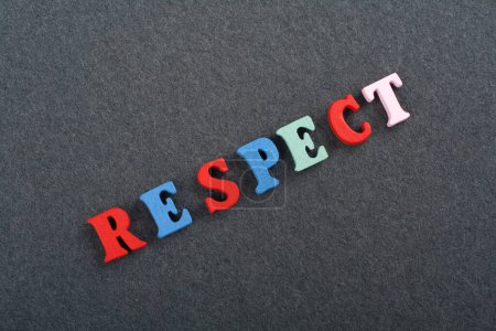 RESPECT word on black board background composed from colorful abc alphabet block wooden letters, copy space for ad text. Learning english concept