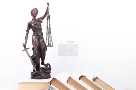 Photo for Law concept - Open law book, Judge's gavel, scales, Themis statue on table in a courtroom or law enforcement office. Wooden table, white background - Royalty Free Image