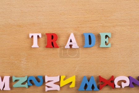 TRADE word on wooden background composed from colorful abc alphabet block wooden letters, copy space for ad text. Learning english concept
