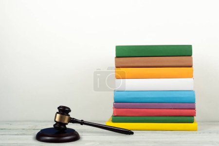 Photo for Law concept open book with wooden judges gavel on table in a courtroom or law enforcement office, blue background. Copy space for text - Royalty Free Image