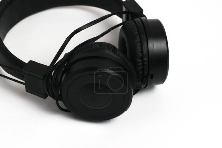 Photo for Black headphones with wire on a white background. Cheap headphones for listening to music. - Royalty Free Image