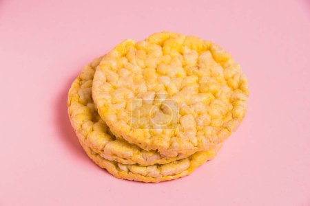 Photo for Tasty, crispy, diet cornbread on paper pink background, side view. Delicious diet food - Royalty Free Image