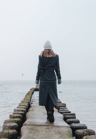 Foto de Mujer en Groynes en el Mar Báltico alemán durante el invierno - Imagen libre de derechos