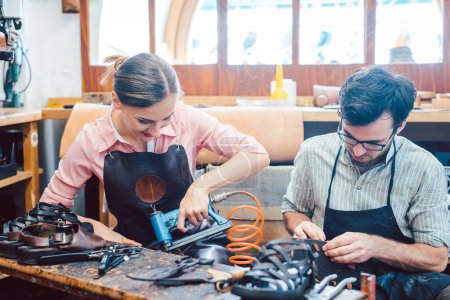 Photo for Woman and man shoemaker working together in the workshop - Royalty Free Image