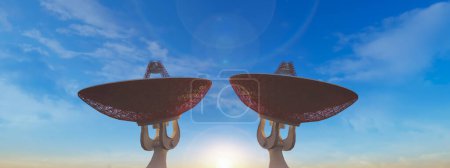 Téléchargez les photos : Les éruptions de soleil matinales entre deux antennes paraboliques imposantes, soulignant l'intersection de la nature et de la technologie. - en image libre de droit