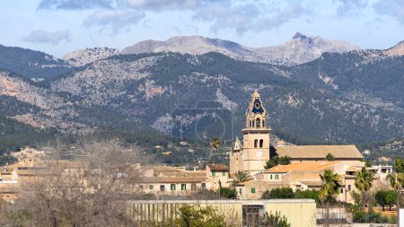 A harmonious blend of the historic Consell village church and the rugged Tramuntana Mountains