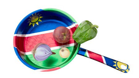 Fresh vegetables and an apple artfully arranged on a vibrant Namibian flag in a frying pan, symbolizing national cuisine.