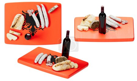 A creative arrangement of traditional Albanian snacks served on a vibrant, orange-hued cutting board adorned with the black, double-headed eagle emblem of Albania's national flag.