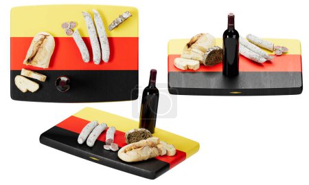 Offrez-vous une sélection d'inspiration allemande avec du pain fraîchement cuit, une variété de fromages et une saucisse fine, associée à une bouteille de vin rouge exquis, contre les couleurs audacieuses du drapeau allemand