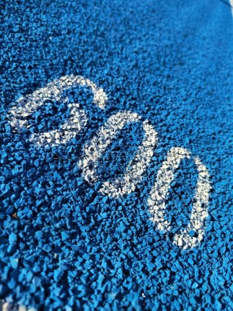 Photo for White 600 number on blue tartan running track - Royalty Free Image