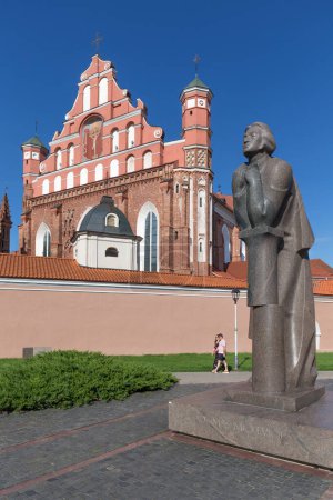 Photo for Vilnius, Lithuania AUGUST 13, 2023. Adam Mickiewicz statue and Church of St. Anne - Royalty Free Image