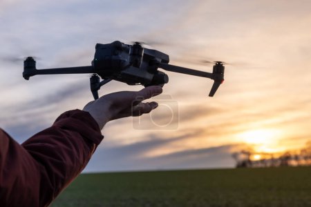 Photo for Drone Pilot Controls Drone to Take Off From Hand - Royalty Free Image