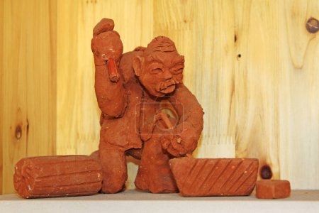 Photo for Clay figurine works by hand in a shop - Royalty Free Image