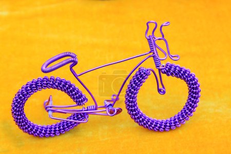 Photo for Bicycle made by iron wire in orange background - Royalty Free Image