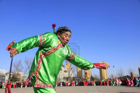 Photo for Luannan County - February 10, 2017: Chinese folk dance Yangko performance on the street, Luannan County, Hebei Province, Chin - Royalty Free Image