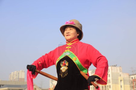 Photo for Luannan County - February 13, 2017: Chinese folk dance Yangko performance on the street, Luannan County, Hebei Province, Chin - Royalty Free Image