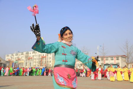 Photo for Luannan County - February 13, 2017: Chinese folk dance Yangko performance on the street, Luannan County, Hebei Province, Chin - Royalty Free Image