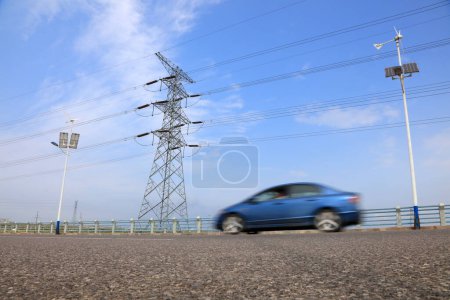 Photo for Electric towers and moving vehicle - Royalty Free Image