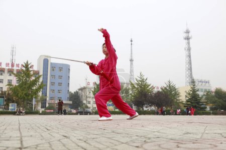 Photo for LUANNAN COUNTY, China - October 15, 2017: Taiji Sword performance in the square, LUANNAN COUNTY, Hebei Province, China - Royalty Free Image
