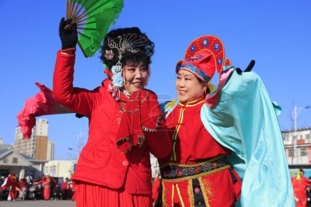 Photo for Luannan County - February 9, 2017: Chinese folk dance Yangko performance on the street, Luannan County, Hebei Province, China - Royalty Free Image