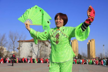 Photo for Luannan County - February 10, 2017: Chinese folk dance Yangko performance on the street, Luannan County, Hebei Province, Chin - Royalty Free Image
